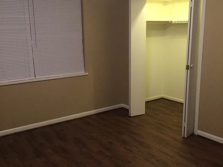 Bedroom with very deep, wide closet.
