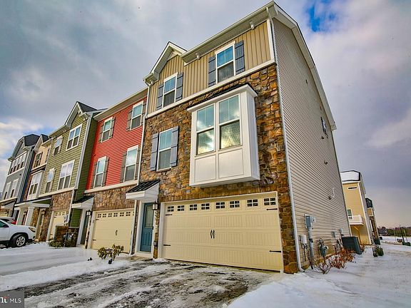 Two-car garage and off-street parking for two more vehicles. Level 2 EV charger inside garage.