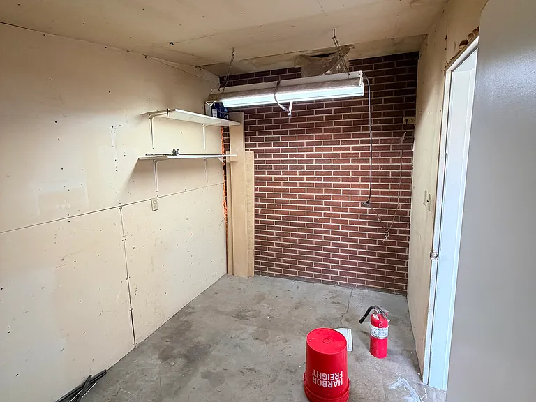 Attached, covered storage area off of garage