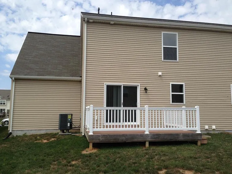 Back porch. Spacious! Also can see the back of the garage on the left.