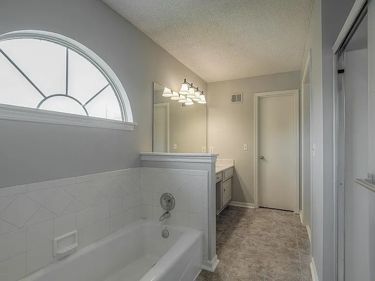 The master bath is calming and spacious.