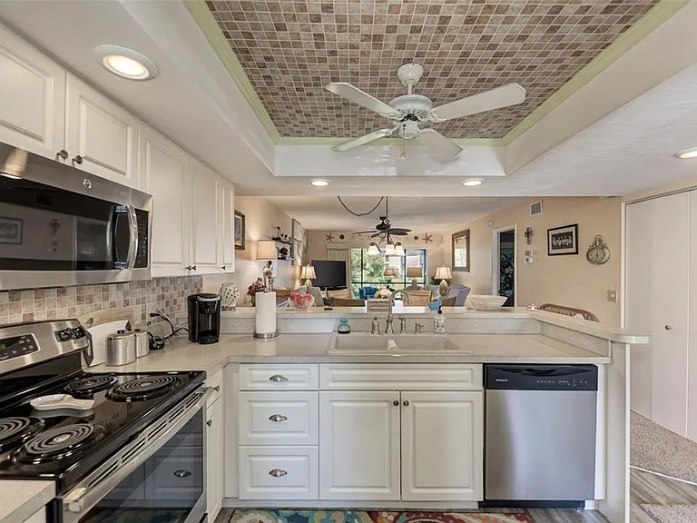 A kitchen you'll actually want to cook in. __ With plenty of storage in those beautiful new cupboards and a neat, organized layout, Unit 1003 makes vacation meals a breeze. Plus, the open view to the dining area ensures the chef is always part of the fun!