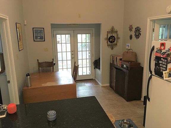 Entryway, eating area and storage benches by front doors with furniture