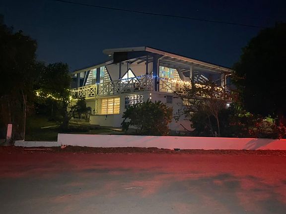 House at night, we have red street lights so the turtles don't come to the beach to lay their eggs. Bright lights attract them.