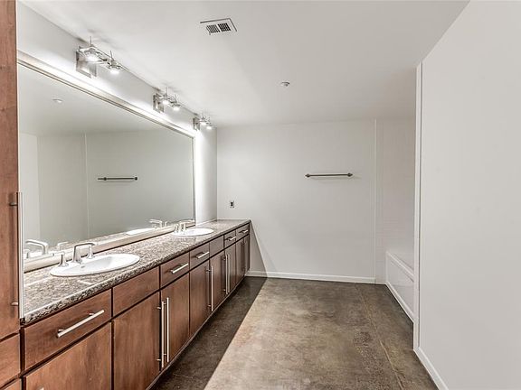 Oversized Bath was recently refreshed in Nov. '21 with new tub/shower combo and subway tile surround and fresh paint! Amazing storage, double sinks, sealed cement floors and separated toilet area!