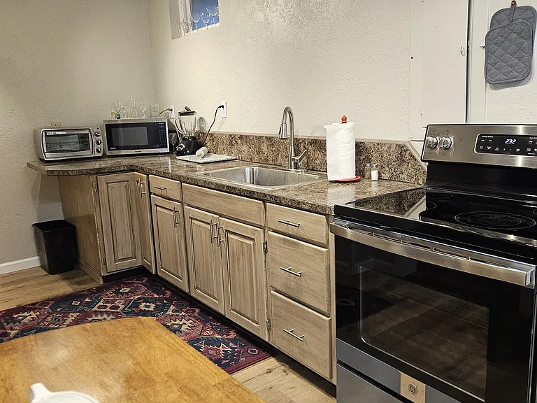 New kitchen, refrigerator, and new stove, microwave, toaster, blender, cooking utensils (pots pans, bowls, plates, silverware)