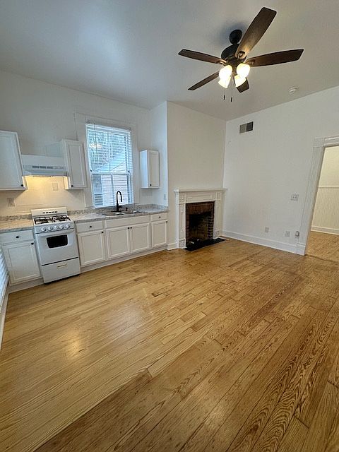 Living area/kitchen with stove/oven and refrigerator