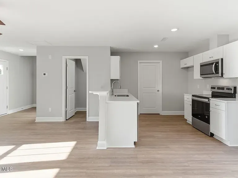Kitchen opens top living room/ 1/2 bath off living room
