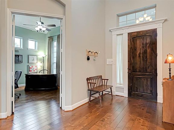 Enter into the grand foyer with high ceilings and spiral staircase.