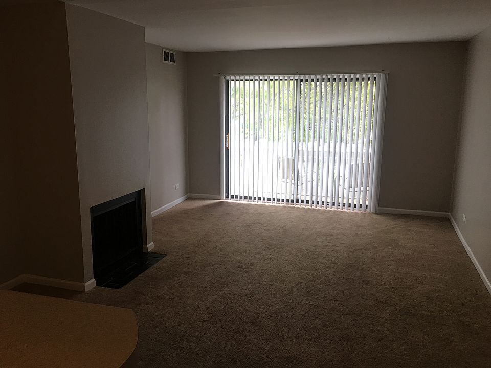 Large family room with a fireplace. Currently all carpets are removed and new modern luxury vynil planks are installed throughout the apartment.
