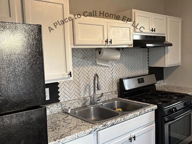 Kitchen includes stove, refrigerator, vent hood and washer and dryer