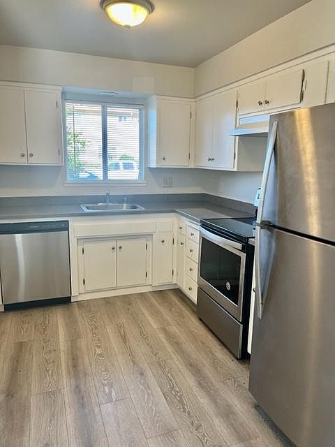 Kitchen: Freshly painted cabinets, updated stainless steel appliances, new: flooring, countertops, blinds, sink & faucet