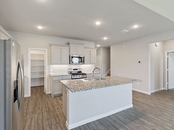 REPRESENTATIVE PHOTO - Kitchen in the Masters home plan by Trophy Signature Homes