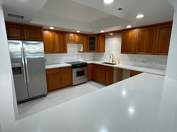Remodeled kitchen with new dishwasher and fridge.