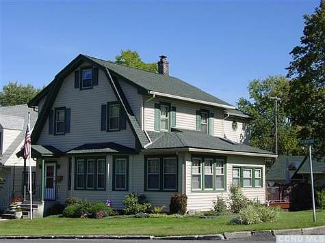 Beautiful Dutch Colonial Revival with rear 12 x 24 two story addition, Trex deck and two car detached garage