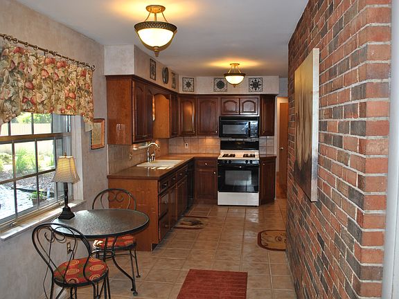 Kitchen with brick wall.
