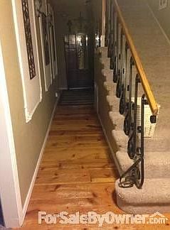 Entry hall from front door.
						:
						Custom wall moldings and 1ft. custom pine antique floors.