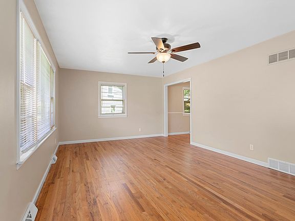 front living room with beautiful hardwoods and lots of windows