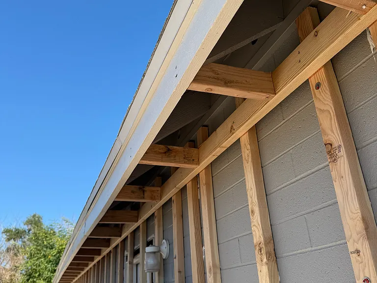 REMODEL: Firred out walls and boxed in wood rafters so everything can become smooth stucco that is foam insulated before styrene board goes on