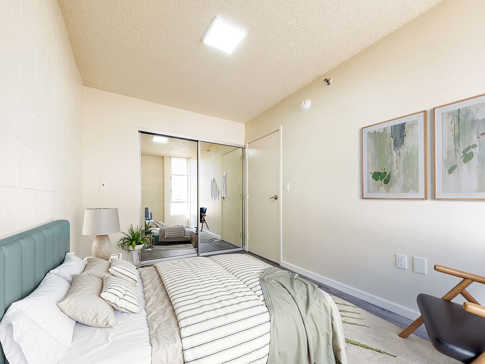 Bedroom with a spacious mirrored closet and ample storage space.