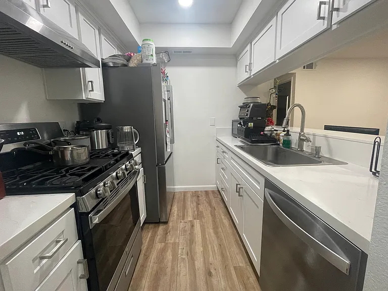 Kitchen includes oven, stove, dishwasher, mono-sink, fridge, microwave, and toaster.