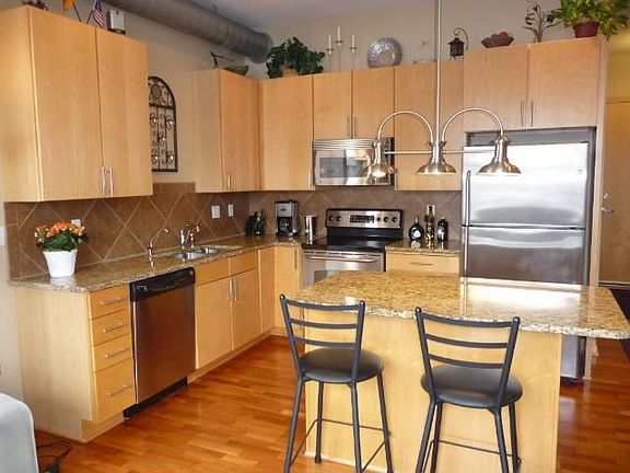 Maple cabinetry and trim, granite counter top, eat-in kitchen island, SS appliances, and closet pantry off to the side - a chef's ideal kitchen!