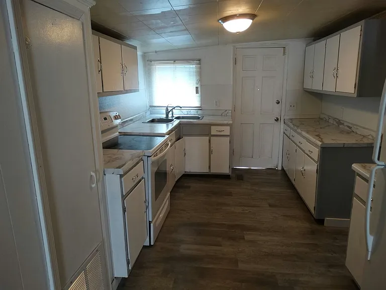 Kitchen with service door entry.