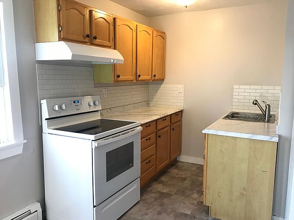 Newly updated kitchen with all brand new stove, counter top, back splash, sink, and flooring.
