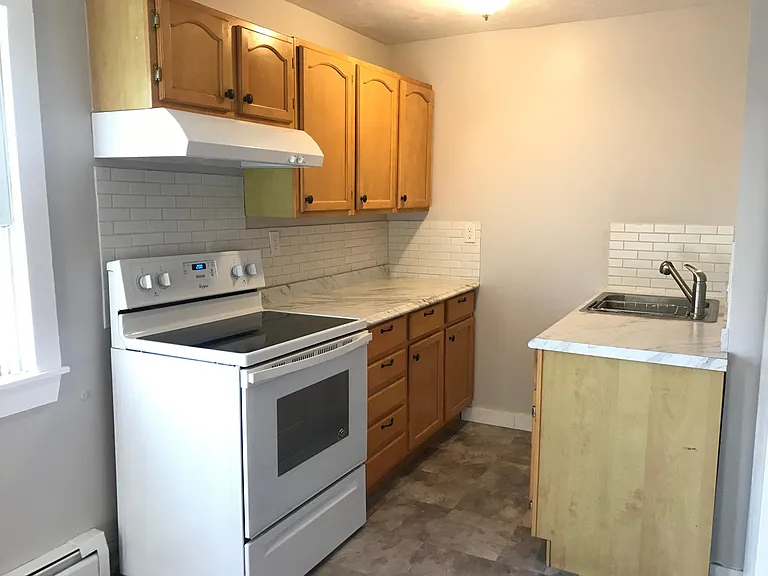 Newly updated kitchen with all brand new stove, counter top, back splash, sink, and flooring.