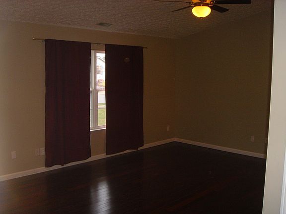 Great room with vaulted ceilings and real walnut wood floors.