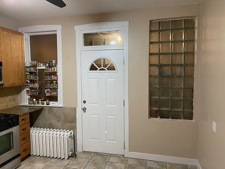 Kitchen rear door of building to enclosed stairwell.