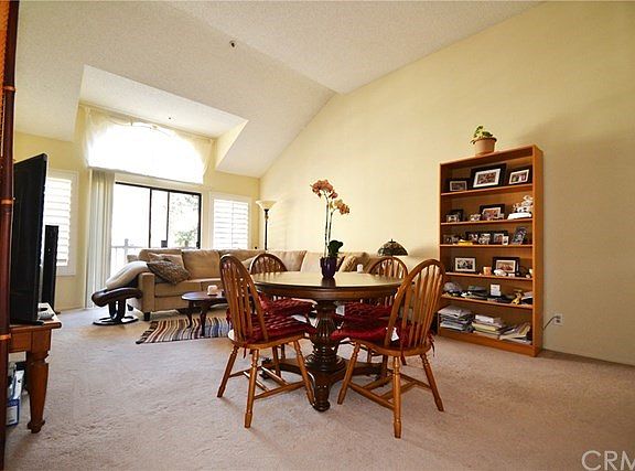 Living Room with soaring vaulted ceiling, custom plantation shutters throughout