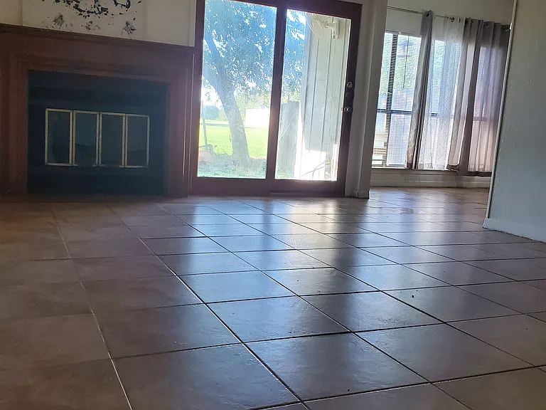Living room with fireplace and French door to the newly built fence back yard