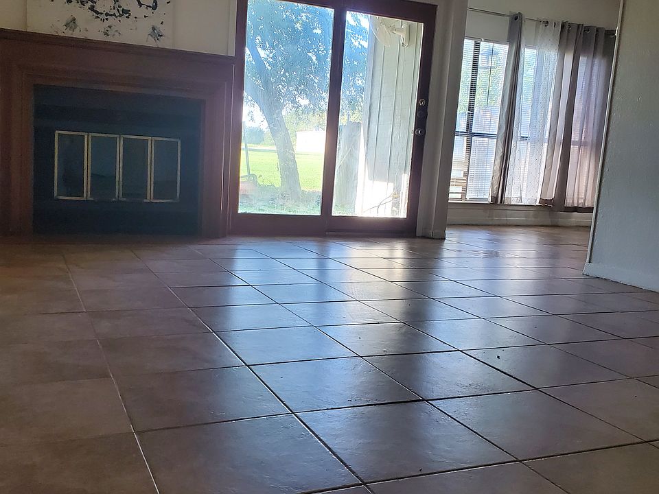 Living room with fireplace and French door to the newly built fence back yard