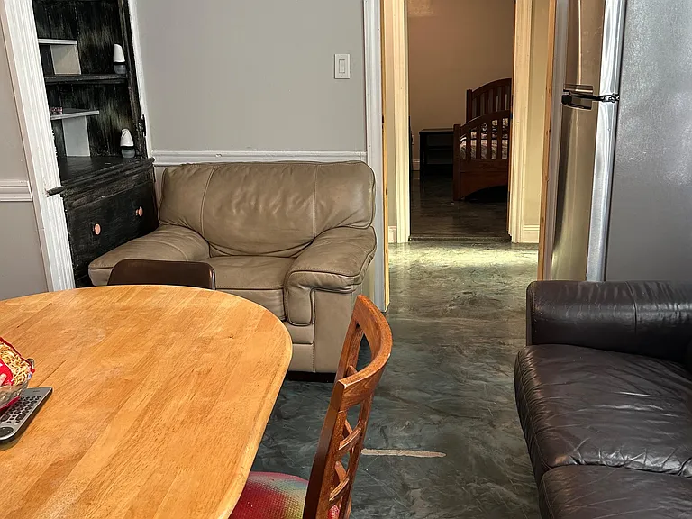 Shared living/dining area with a table setup, lounge seating, built-in shelving, and easy access to the kitchen.