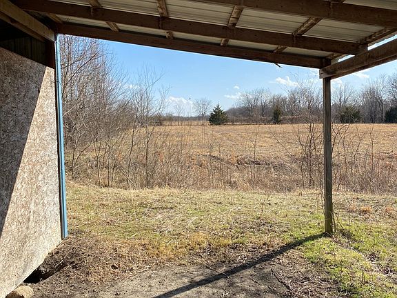 Under loafing shed facing south of property.