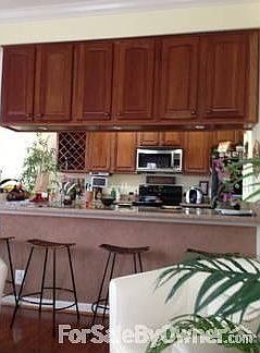 View over countertop into kitchen
						:
						Open plan kitchen, family room, sunroom - silestone countertops, cherry cabinets