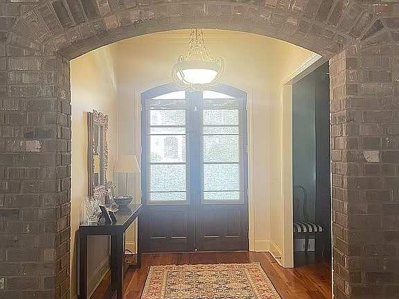 Foyer with brick archway 