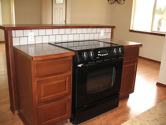 Island in the kitchen, with raised bar on backside.