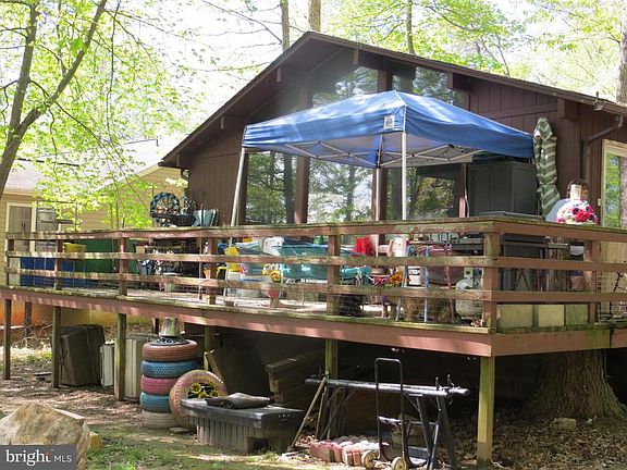 wrap around deck with view of trees & golf course