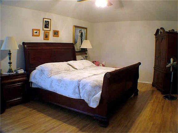 Laminate flooring in this spacious Masters Bedroom. Decors  are from past owners.  Will update new photo soon.