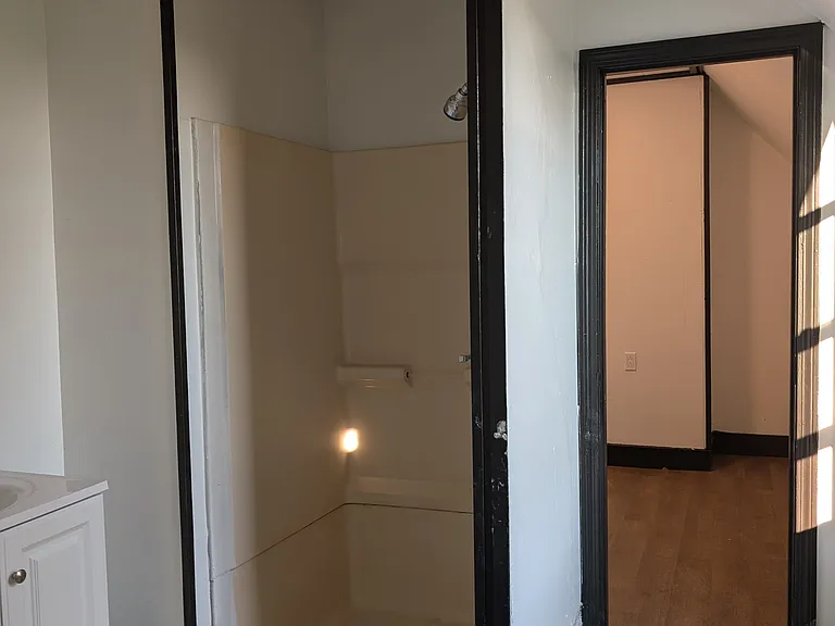 Bathroom view of the shower facing the smaller bonus room.