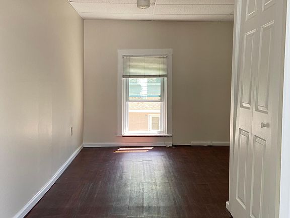 View of bedroom from private side entrance. New Pergo wood floor installed and a fresh coat of paint on all walls.