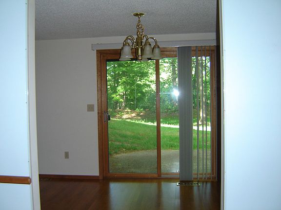This view shows the dining room patio door that leads to a small patio and the private back yard common area.  You will have your own park-like view.