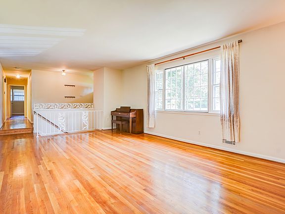 Living room -- large front window bring in loads of light! *Piano stays with the home