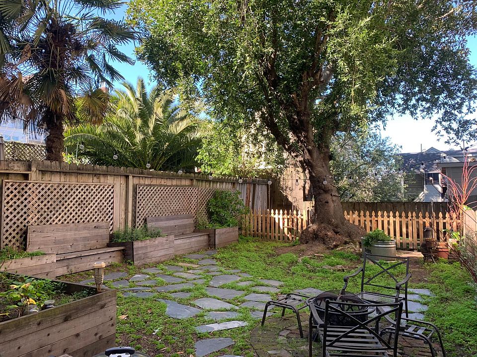 60 x 25 foot shared yard with fenced grassy area in the back, and fire pit.