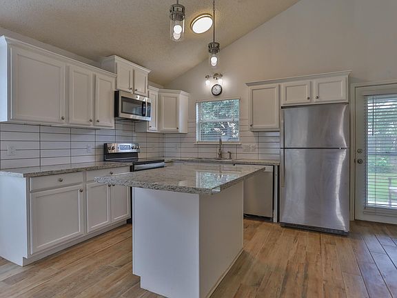 Roomy kitchen, island, granite countertops, stainless appliances, 6127 8th Drive