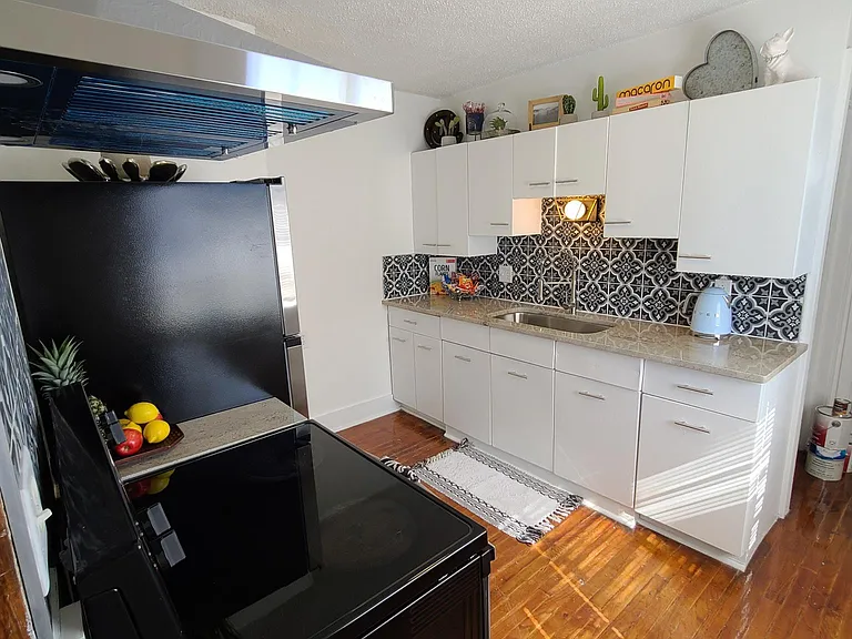 Kitchen with new Granite Countertops with Original Metal Cabinets, Stainless Steel Appliances, and Custom Tile Backsplash