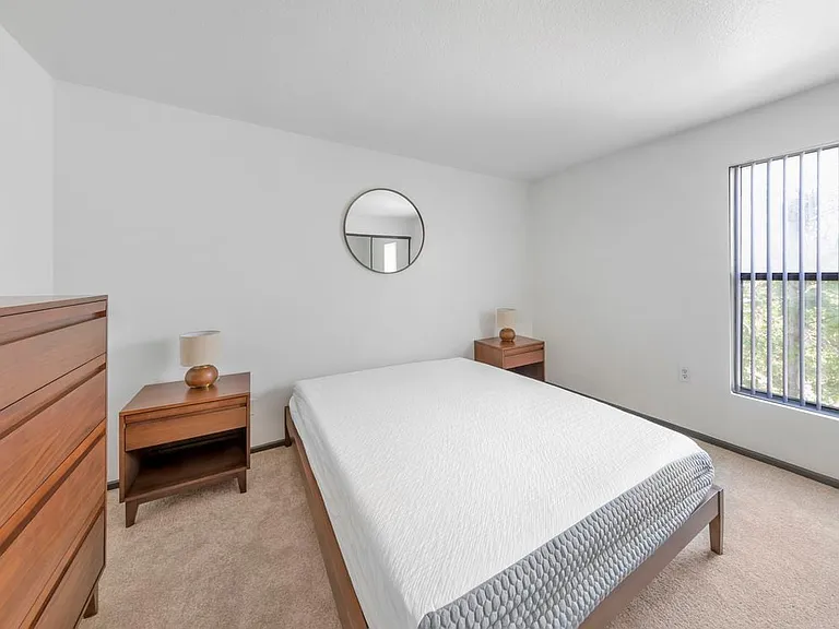 Furnished+ apartment homes feature queen bed with mattress, dresser, nightstands, and lamps (Representative Image exact items and style of furnishings may vary)