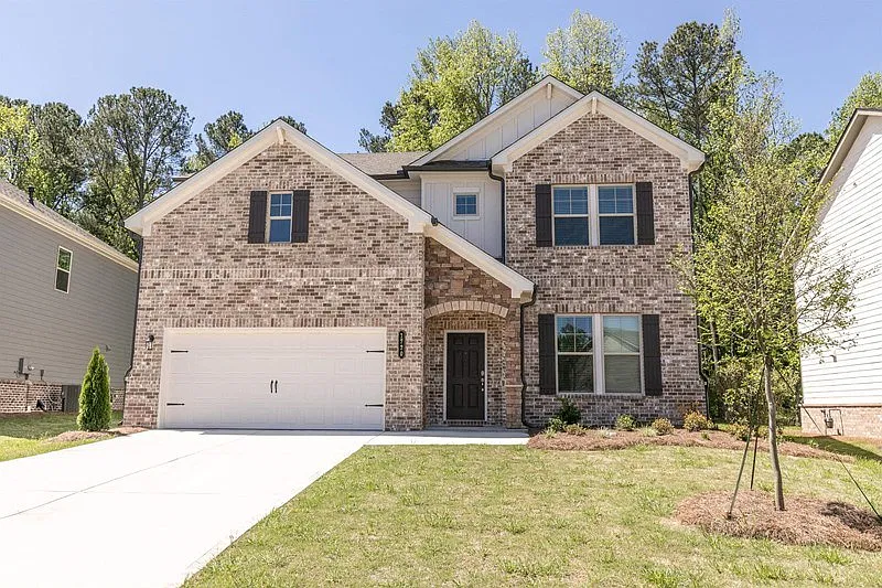Exterior of the Atwood, two story home with a private driveway and attached garage.